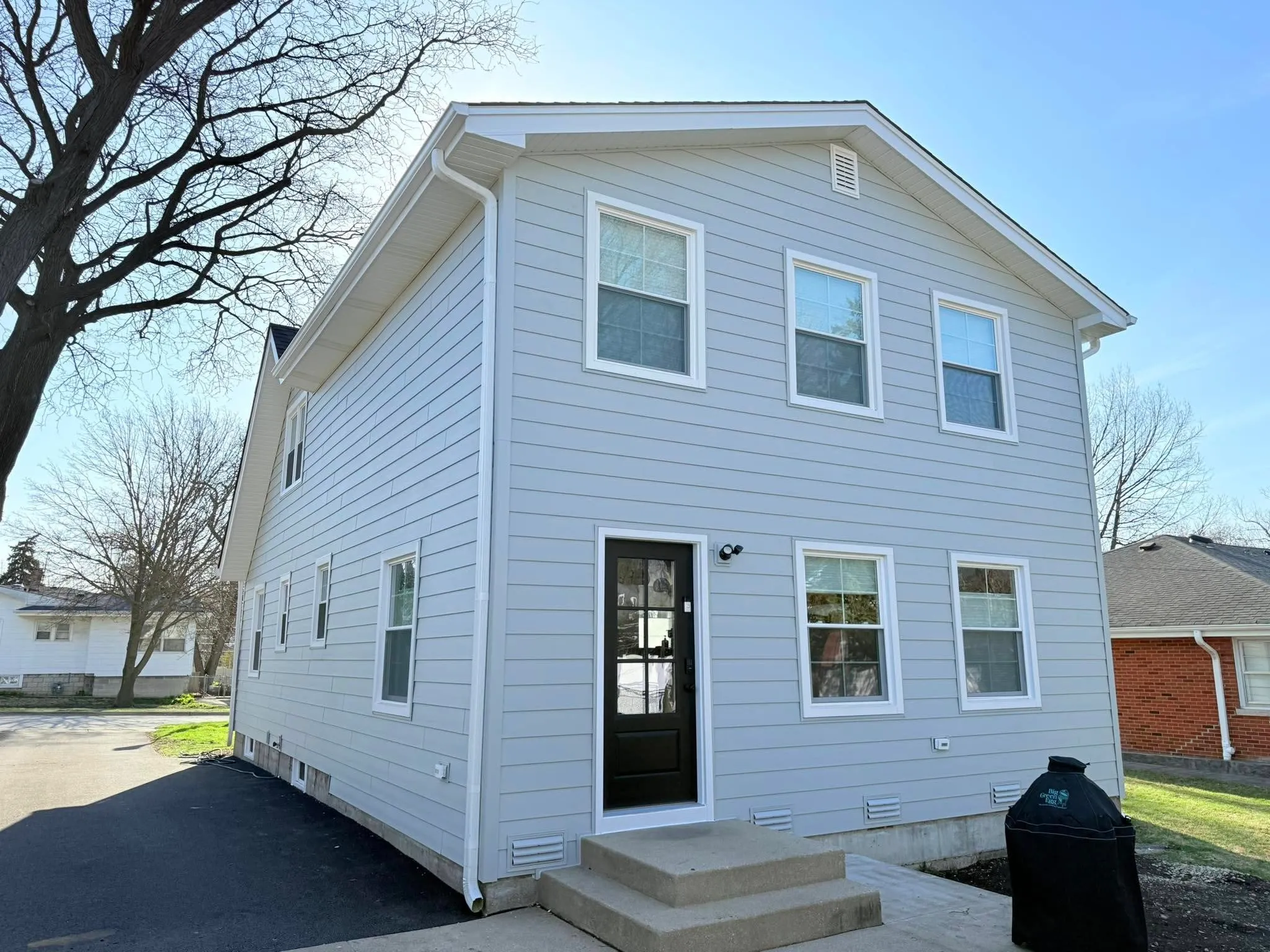 Siding installation elmhurst white home exterior — completed home improvement project by Durabuilt Home Improvements in the Elmhurst, Illinois area
