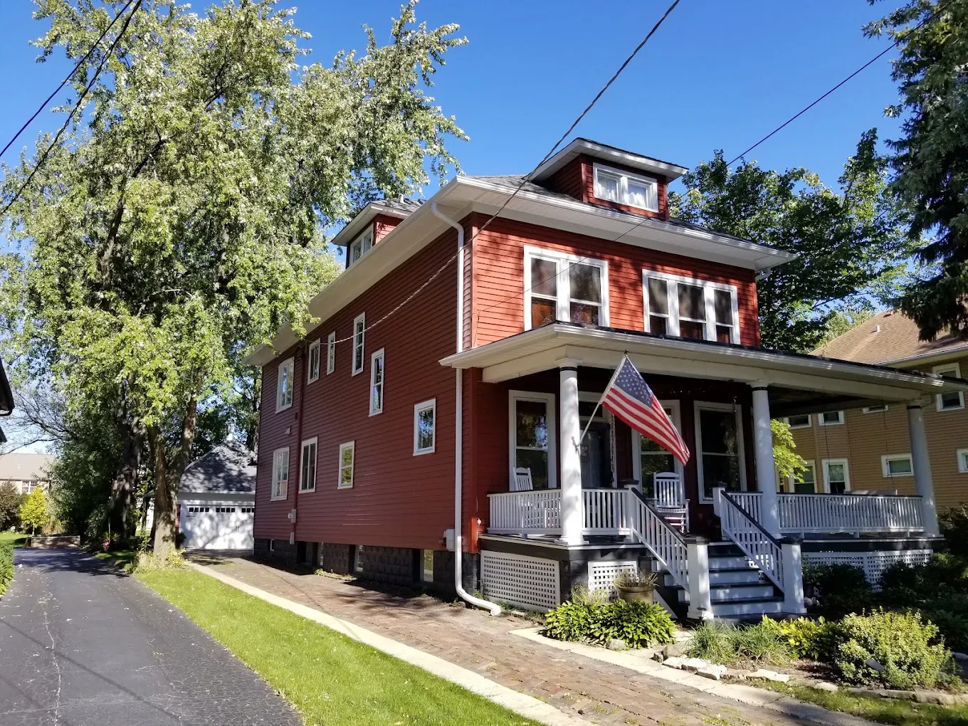 Two-story Elmhurst, Illinois home with new red siding and trim completed by Durabuilt after more than 20 years in business